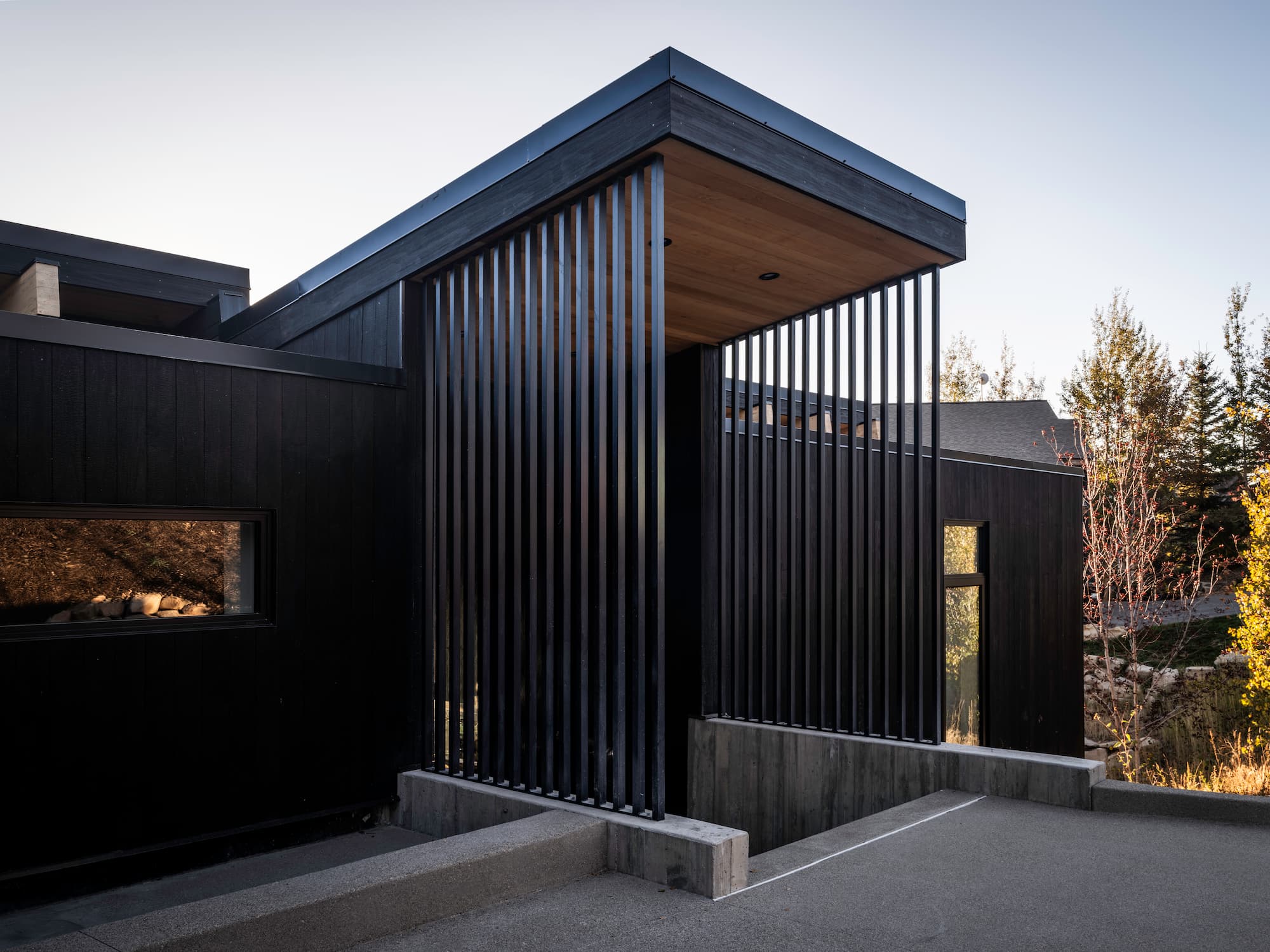 Modern vertical slat screen and wood soffit detail at Pinetop custom home - Park City contemporary architecture by Moncrief Construction